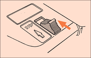[Image] Stop switch with an orange arrow showing which way to move the button into the stop position. 