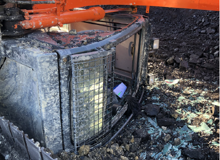 [Image] excavator cab tipped on side. 