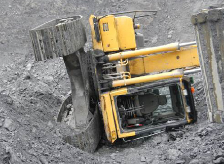 [Image] yellow excavator tipped on side on ore stockpile. 