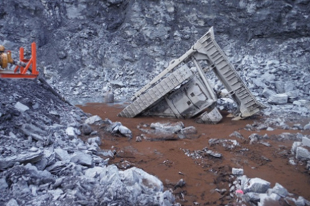 [image] Partially submerged bulldozer in a mine