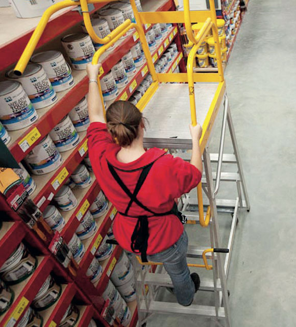 [image] To reach high shelves a worker climbs a ladder correctly, maintaining three points of contact